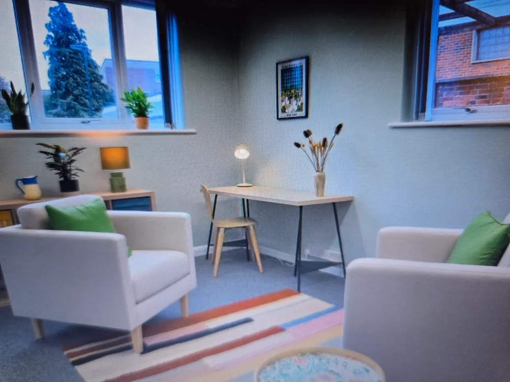 A bright room with cream armchairs at Chichester Therapy Rooms