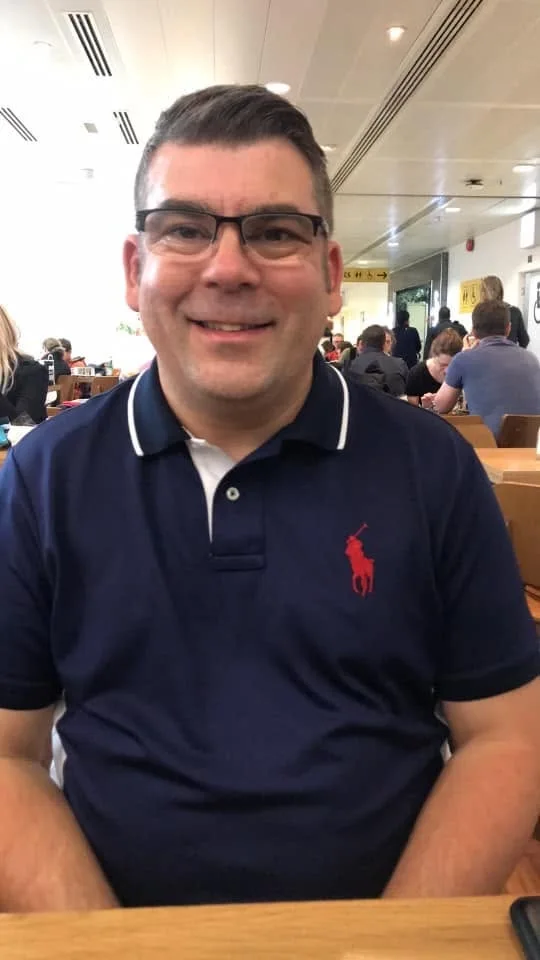 An informal photograph of Ian wearing glasses